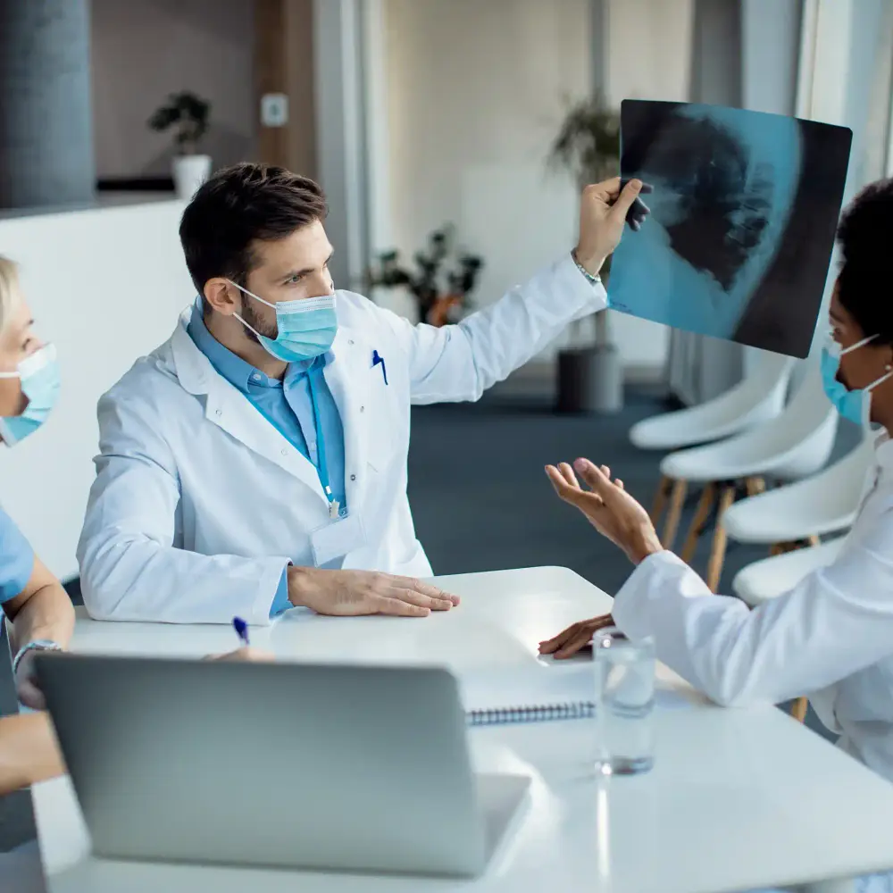 Healthcare experts examining an X-ray in a clinic